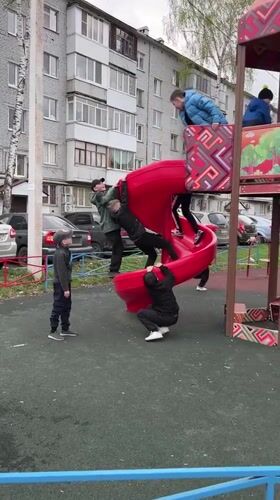 Children play at Ufa playground on overcast day
