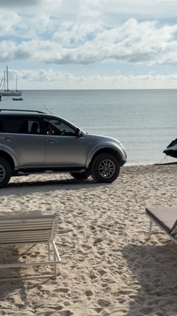 Jet skis, boats, and beach activity at a coastal spot