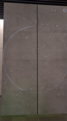 Earth projection displayed on segmented wall with starfield
