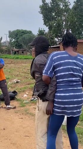 Young men play informal soccer match on dirt field in Riyom
