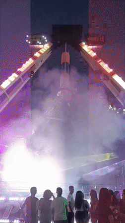 Summer fairground night in Viadana, rides and crowds in full swing