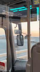Bus travels over water near Yokohama under dusky sky