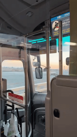 Bus travels over water near Yokohama under dusky sky