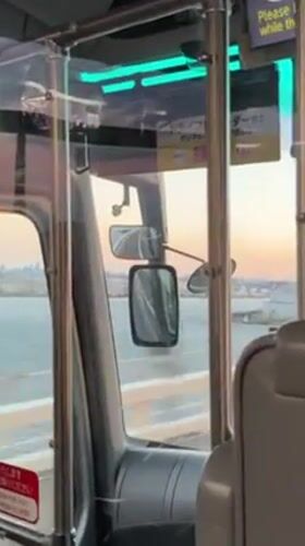 Bus travels over water near Yokohama under dusky sky