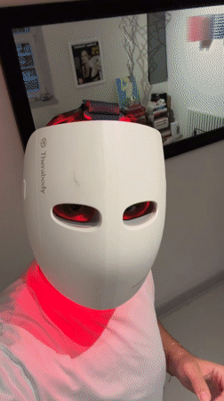Therabody LED face mask glowing red in close-up
