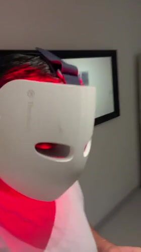 Therabody LED face mask glowing red in close-up