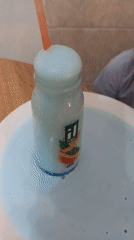 Child experiments with blue liquid during home cooking session