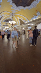 Afternoon pedestrian activity captured at decorated Moscow metro station
