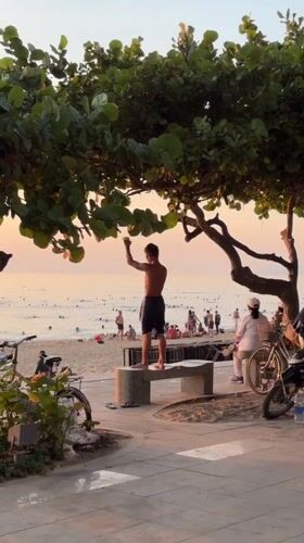 Tai chi group and sunset crowds along Nha Trang's beachfront