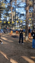 Outdoor gathering in Berjo features dancing and group activities under yellow lanterns
