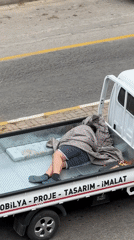 Person rests in pickup truck bed in Fethiye
