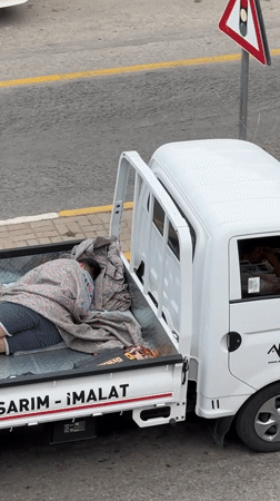 Person rests in pickup truck bed in Fethiye