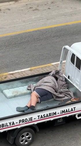Person rests in pickup truck bed in Fethiye