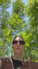 Woman documented walking forest paths, ants observed near purple object