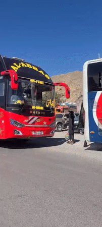 Decorated bus and loaded rickshaw spotted on Pakistan roadside