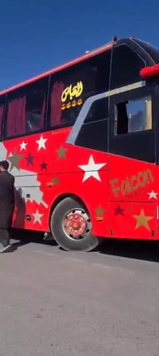 Decorated bus and loaded rickshaw spotted on Pakistan roadside