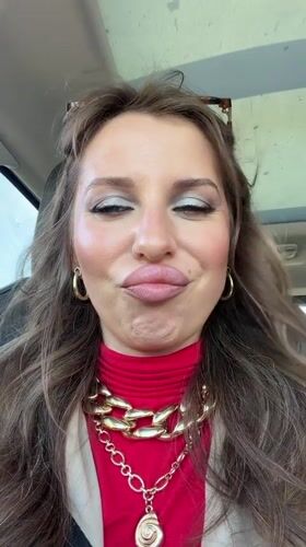Woman photographed in car wearing red turtleneck in Bat Yam
