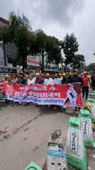 Organized march with banner proceeds through Dhaka streets