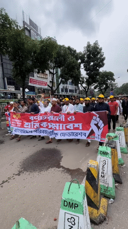Organized march with banner proceeds through Dhaka streets