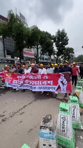 Organized march with banner proceeds through Dhaka streets