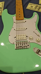 Electric guitar surrounded by cash documented in Denpasar