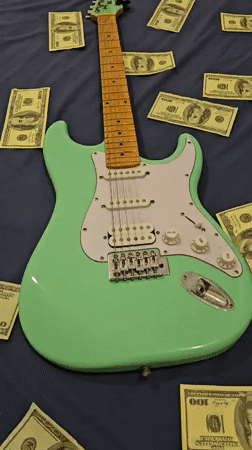 Electric guitar surrounded by cash documented in Denpasar