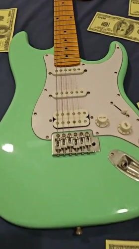 Electric guitar surrounded by cash documented in Denpasar