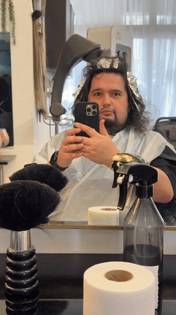 Man takes selfie during hair highlighting appointment in Jerusalem salon