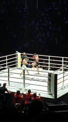 Kickboxing match underway in Bangkok ring with referee present