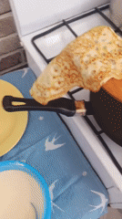 Young girl makes pancakes in kitchen with adult supervision
