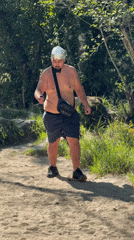 Young men gather in Portuguese woods, one wearing foil hat