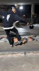 Skateboarder practices tricks at Buenos Aires skateparks during evening session