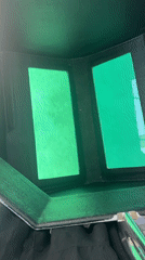 Boat moving along the Greek coastline, welding helmet close-up nearby