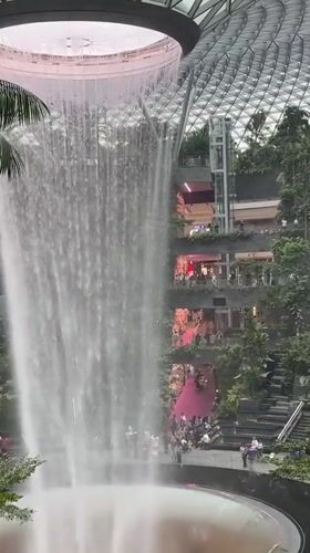 Visitors capture Singapore's Jewel Changi Airport waterfall during morning hours