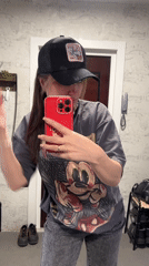 Woman captures casual selfies with cat in home setting
