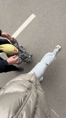 Three people walk on asphalt captured in overhead video