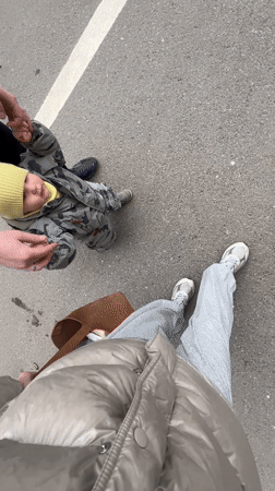 Three people walk on asphalt captured in overhead video