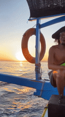 Pirate hat and peace signs on a blue boat in Indonesia