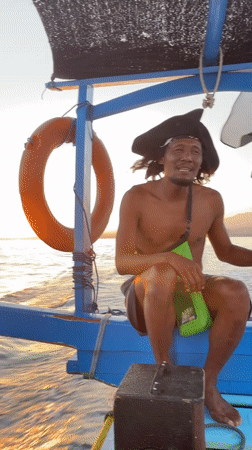 Pirate hat and peace signs on a blue boat in Indonesia