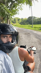 Motorcycle riders travel rural road in Selemadeg Timur, Indonesia