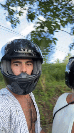 Motorcycle riders travel rural road in Selemadeg Timur, Indonesia