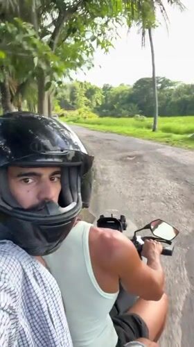 Motorcycle riders travel rural road in Selemadeg Timur, Indonesia