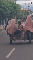 Sidecar motorcycle carries multiple passengers in Baroh, Indonesia