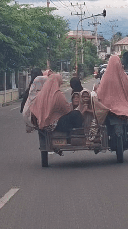 Sidecar motorcycle carries multiple passengers in Baroh, Indonesia