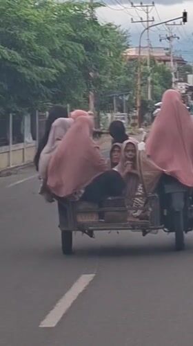 Sidecar motorcycle carries multiple passengers in Baroh, Indonesia