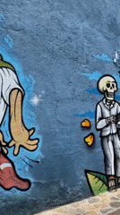 Tourist documents Day of Dead murals, colonial architecture in Oaxaca