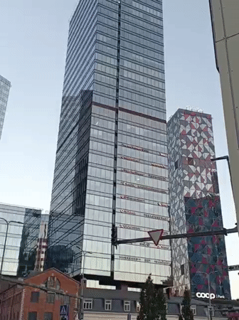 Street-level look at Tallinn's modern glass skyscraper district