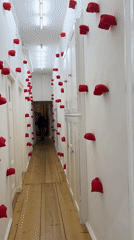 Evening gallery opening in Berlin with sculptures, installations, and film projections