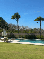 Quiet Balinese villa poolside with traditional stone and wood details