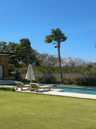 Quiet Balinese villa poolside with traditional stone and wood details
